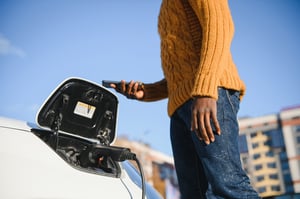 african-american-man-charging-his-electric-car-2024-02-02-23-41-27-utc
